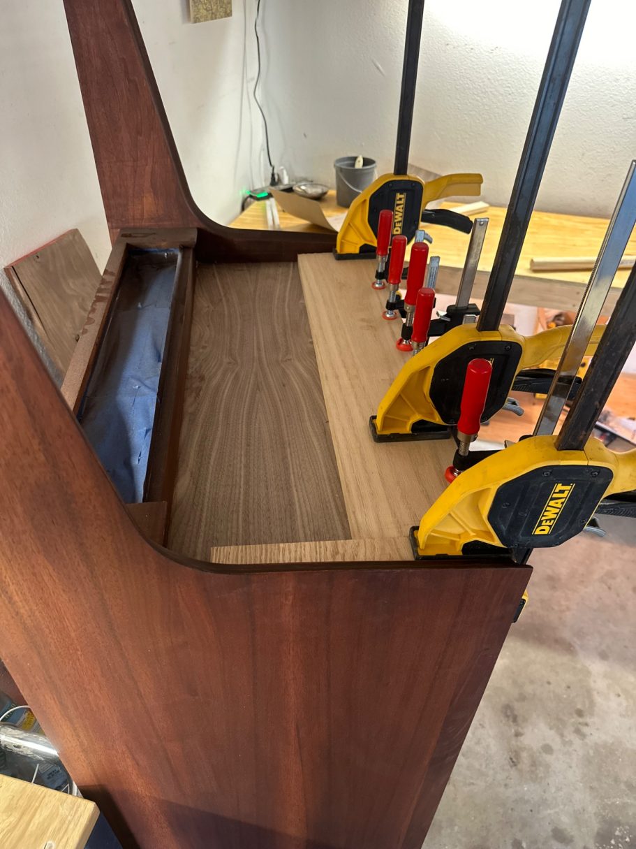 Professional furniture repair in DFW showing veneer clamping on a mid-century highboy.